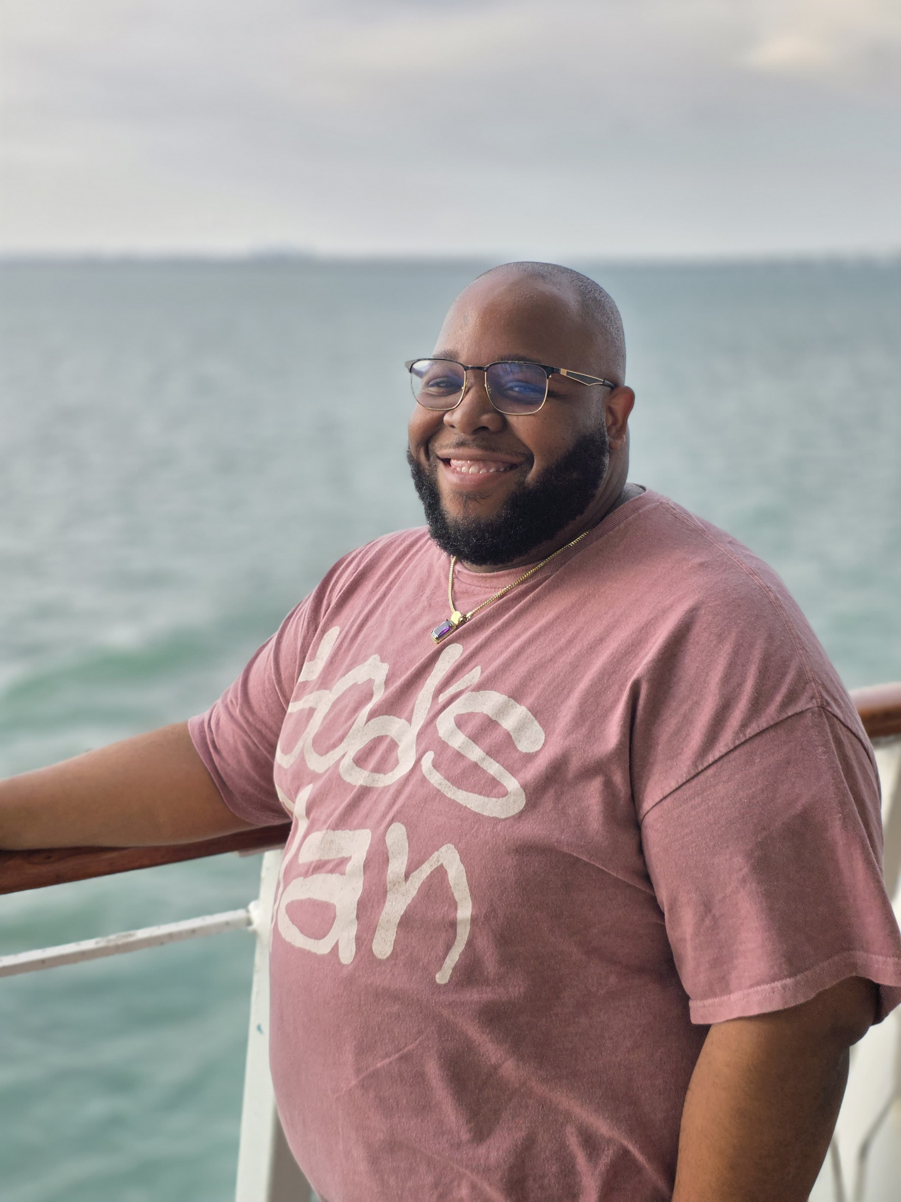 Howard D'Oyley II smiling on a cruise ship deck
